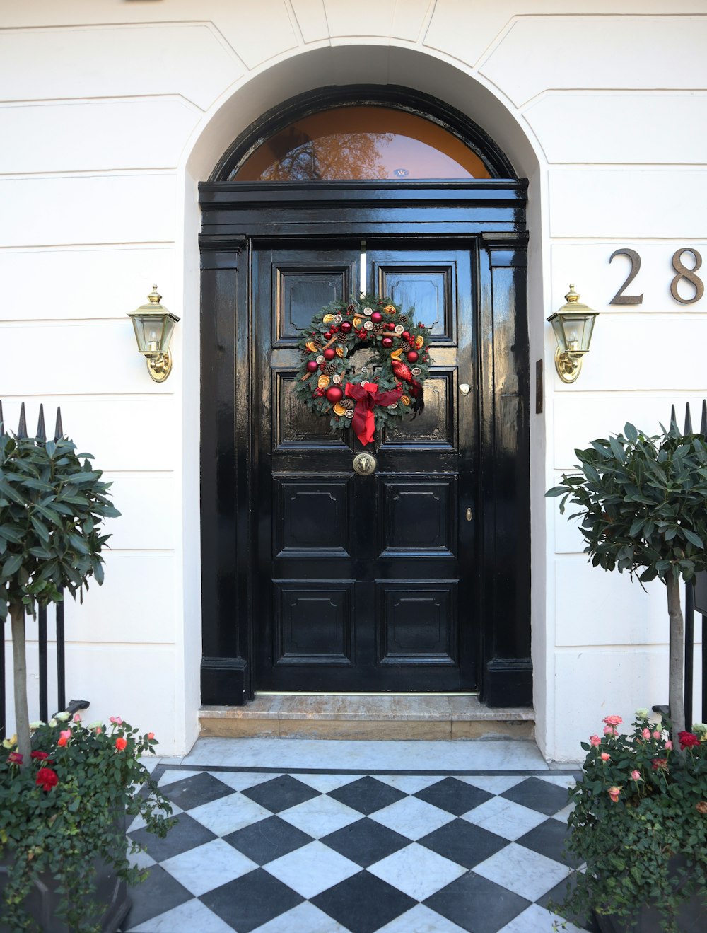 black wooden door with red flowers