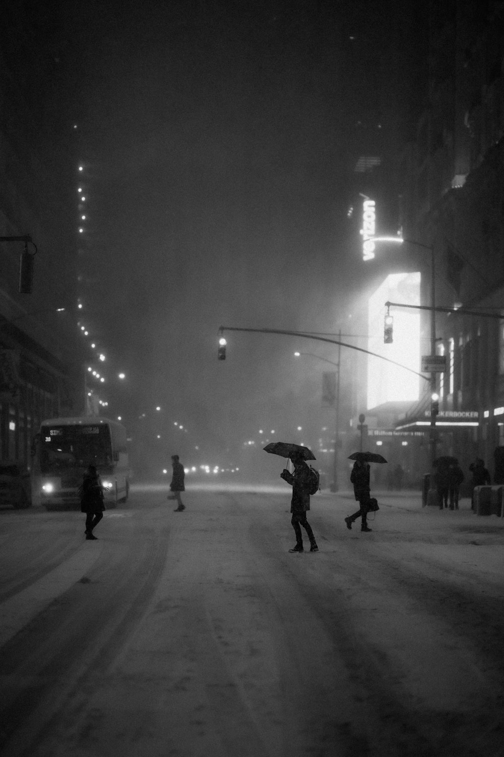 grayscale photo of man and woman walking on street