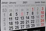 A 2021 calendar page displaying the month of January in multiple languages at the top. The calendar is arranged in a grid with dates and days of the week labeled in several languages, including German, French, and Spanish. Some dates are highlighted in red, marking special days or weekends.
