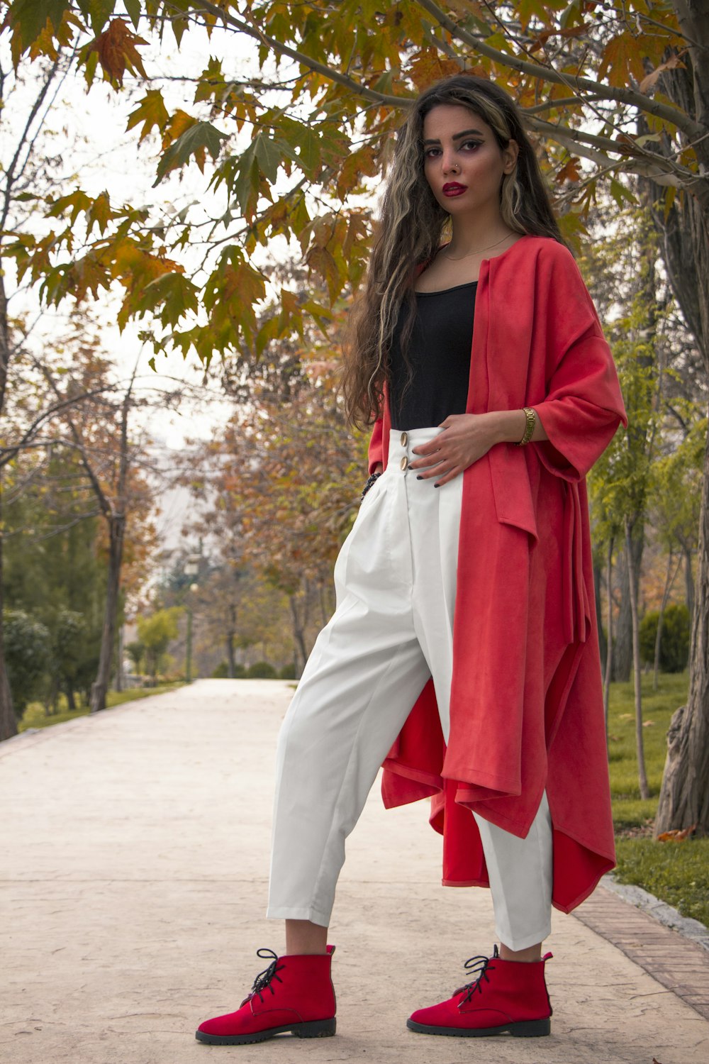 woman in red long sleeve dress standing on road during daytime