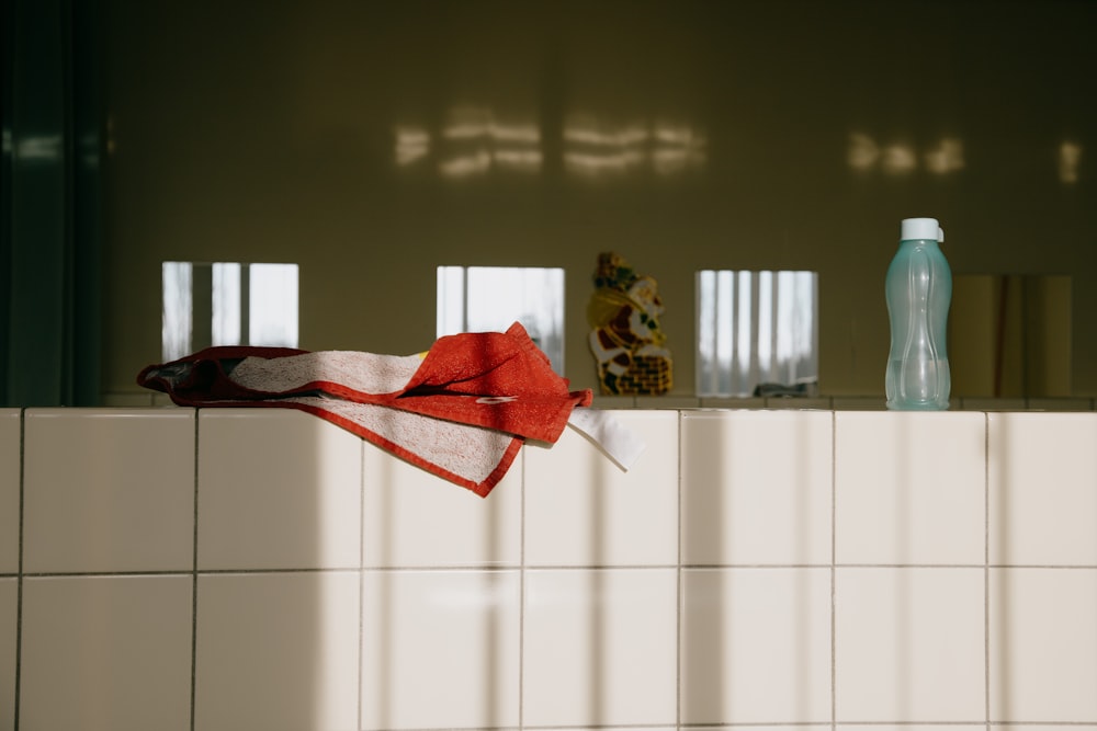 red textile on white tiles