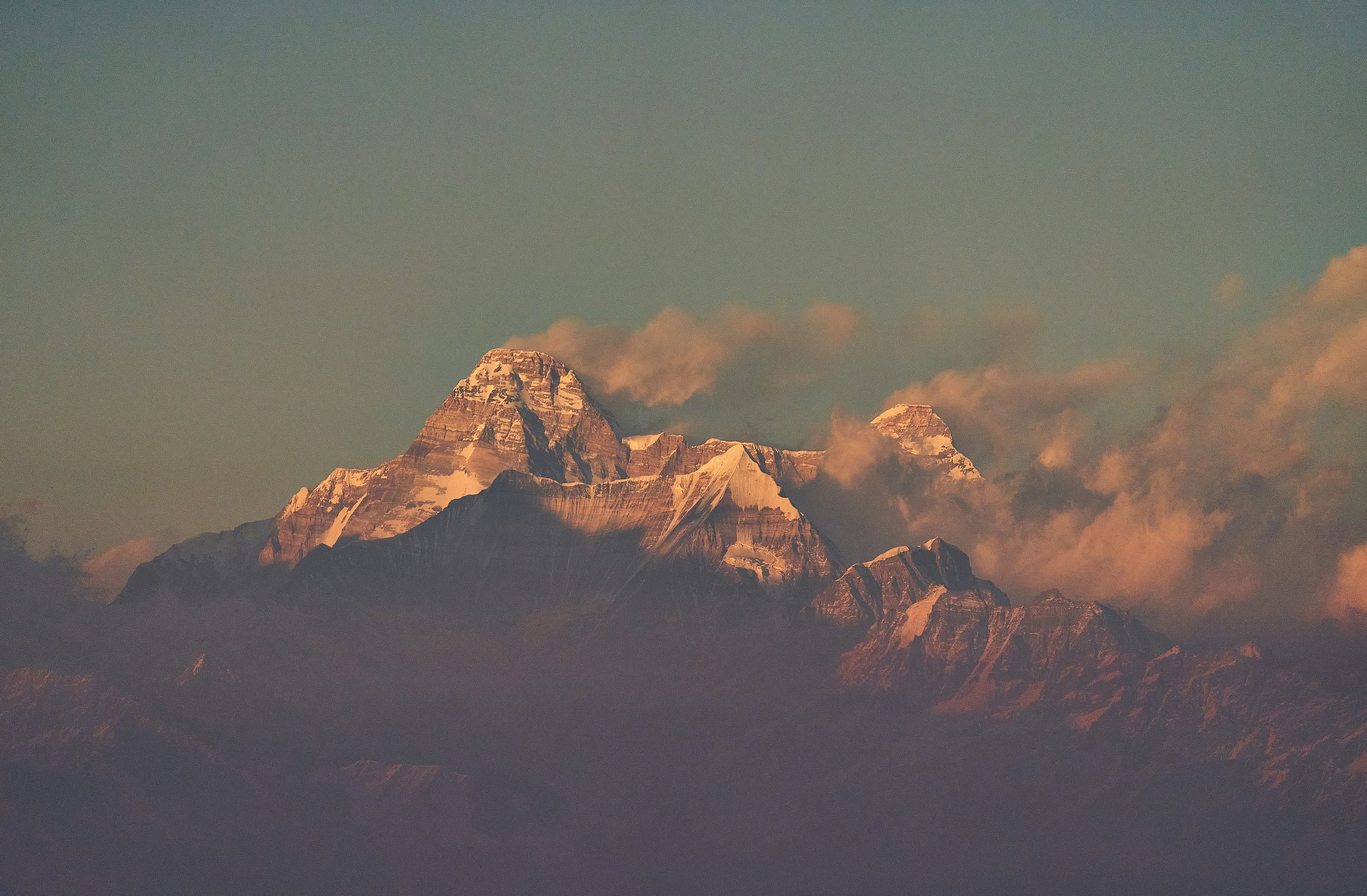 brown and white mountains under gray sky