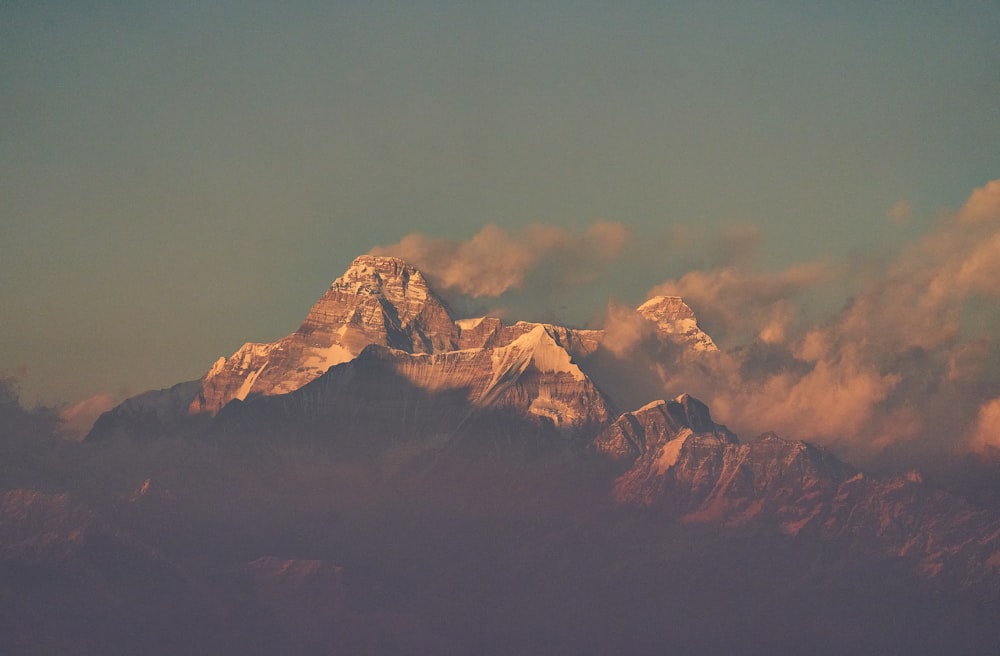 brown and white mountains under gray sky