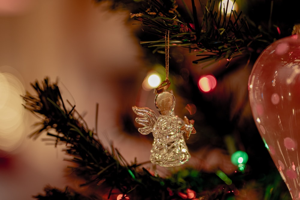 silver christmas tree ornament on green christmas tree