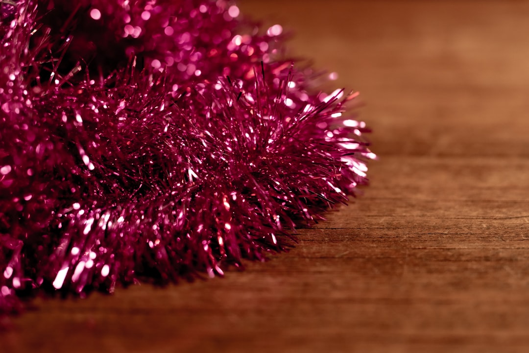 pink and white fur on brown wooden table