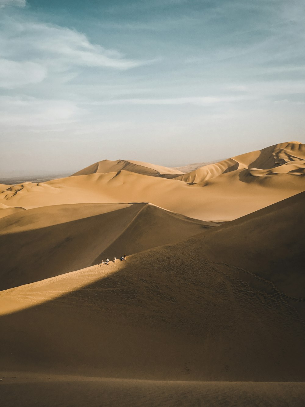 brown sand under white sky during daytime