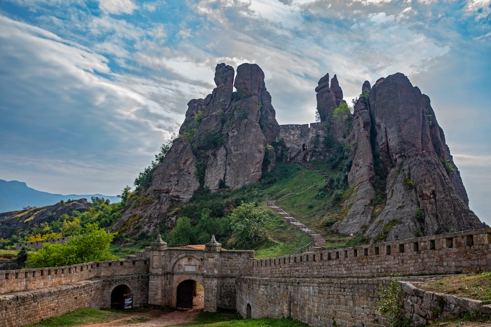 brown concrete bridge on mountain during daytime