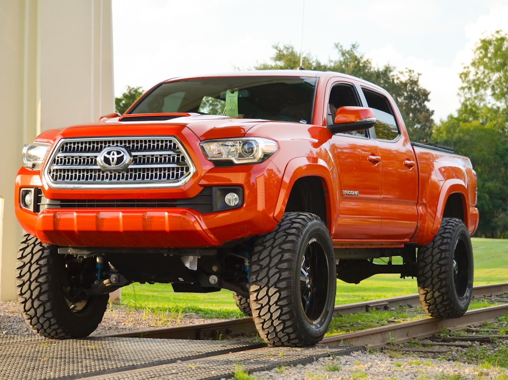 red chevrolet crew cab pickup truck