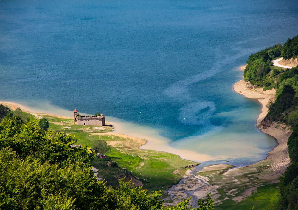 aerial view of green grass field near body of water during daytime