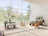 A bright, airy villa living room with large windows overlooking a garden.