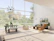 A bright, airy villa living room with large windows overlooking a garden.