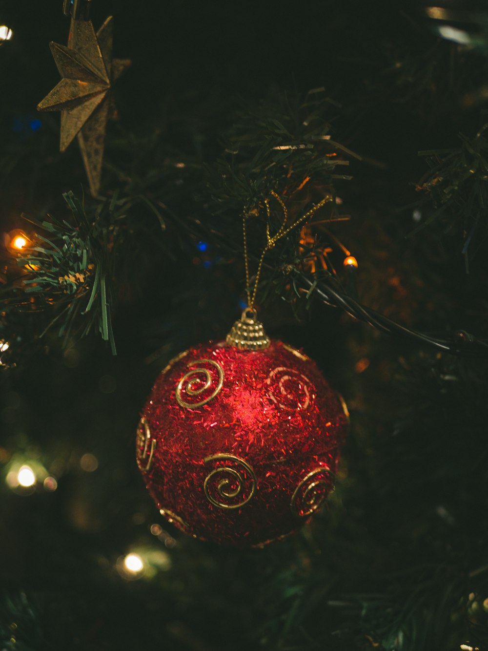 red and gold bauble on christmas tree
