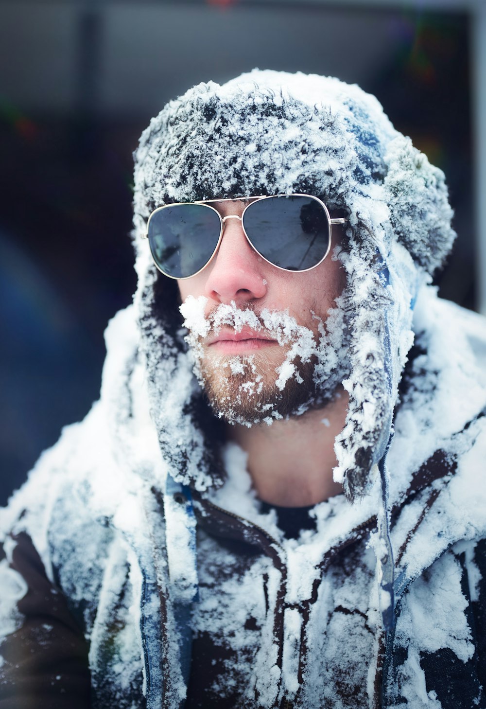 man in black and white jacket wearing aviator sunglasses