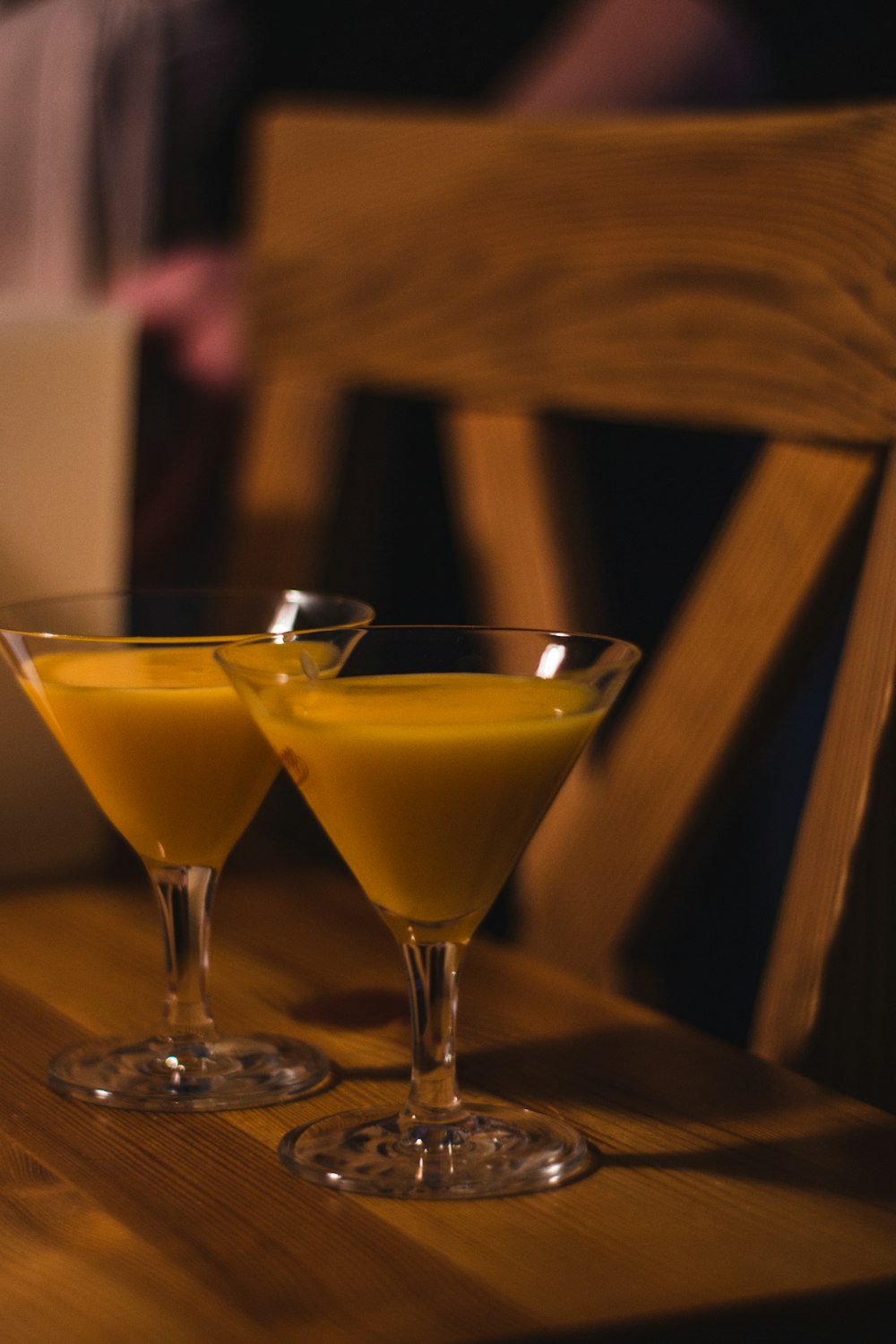 clear cocktail glass with yellow liquid inside