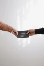 person in brown long sleeve shirt holding black book
