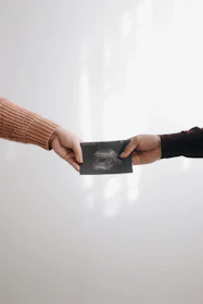person in brown long sleeve shirt holding black book