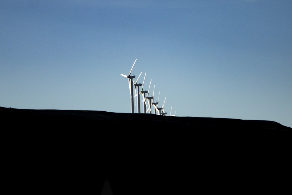 wind turbines under blue sky during daytime