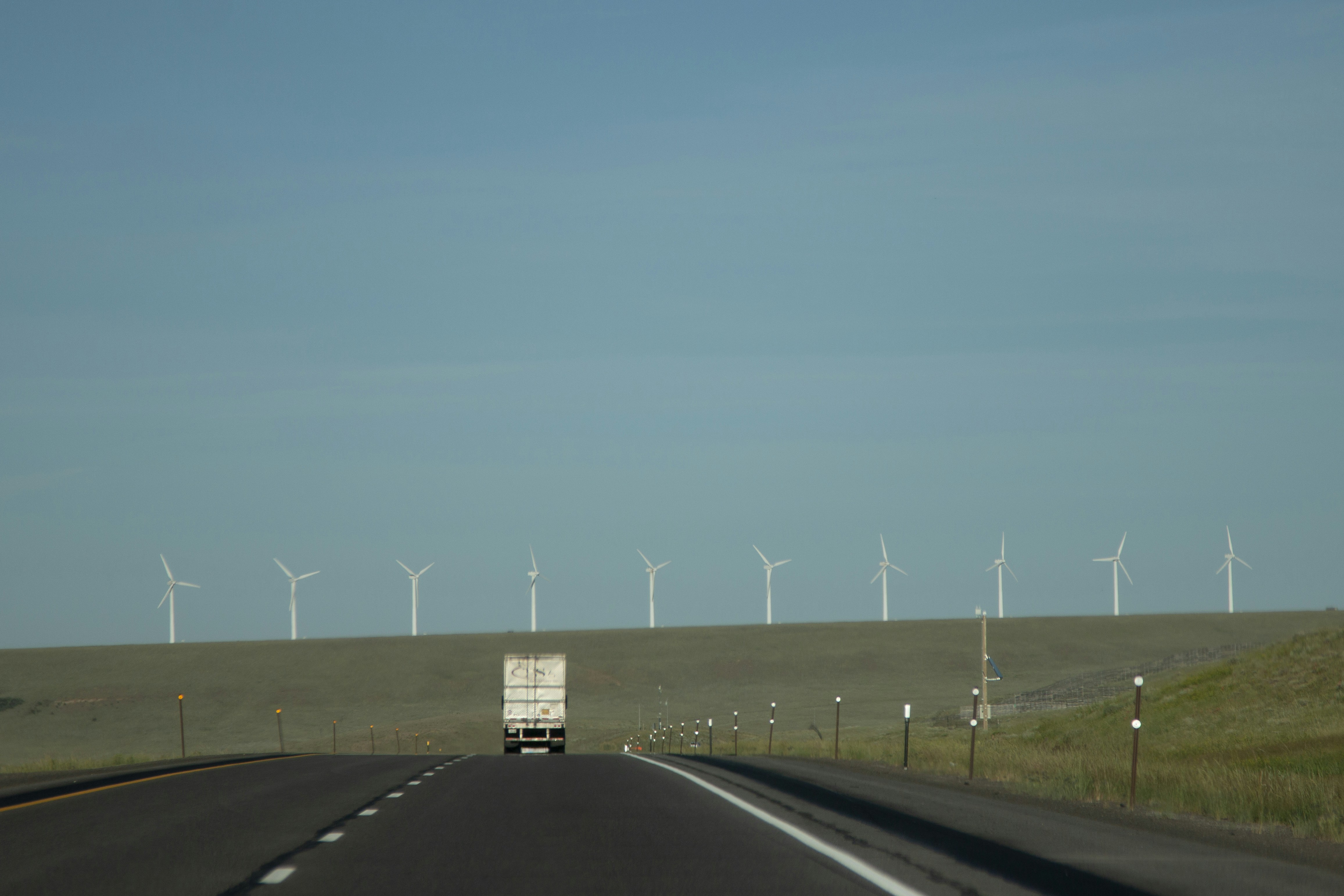 gray asphalt road under blue sky during daytime