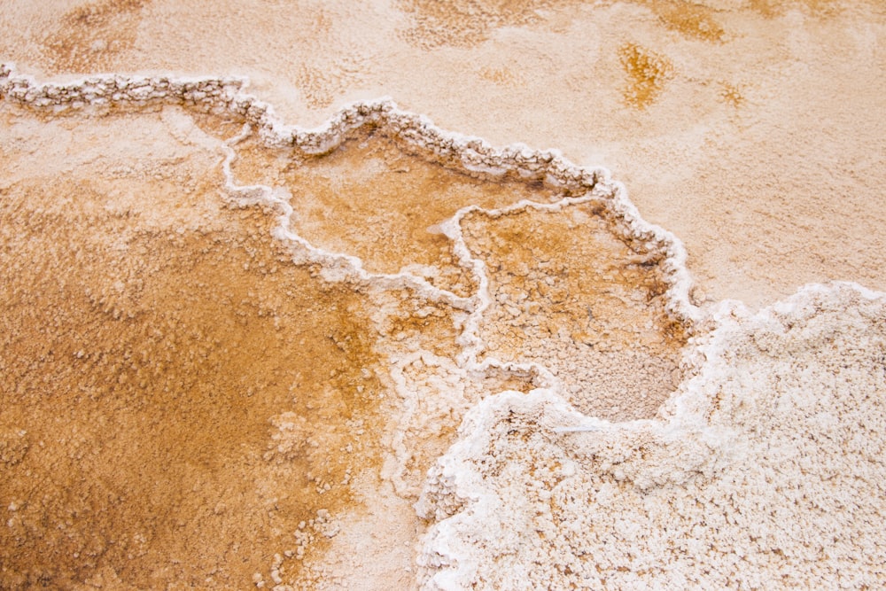 brown sand with water waves