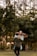 man and woman kissing in forest during daytime