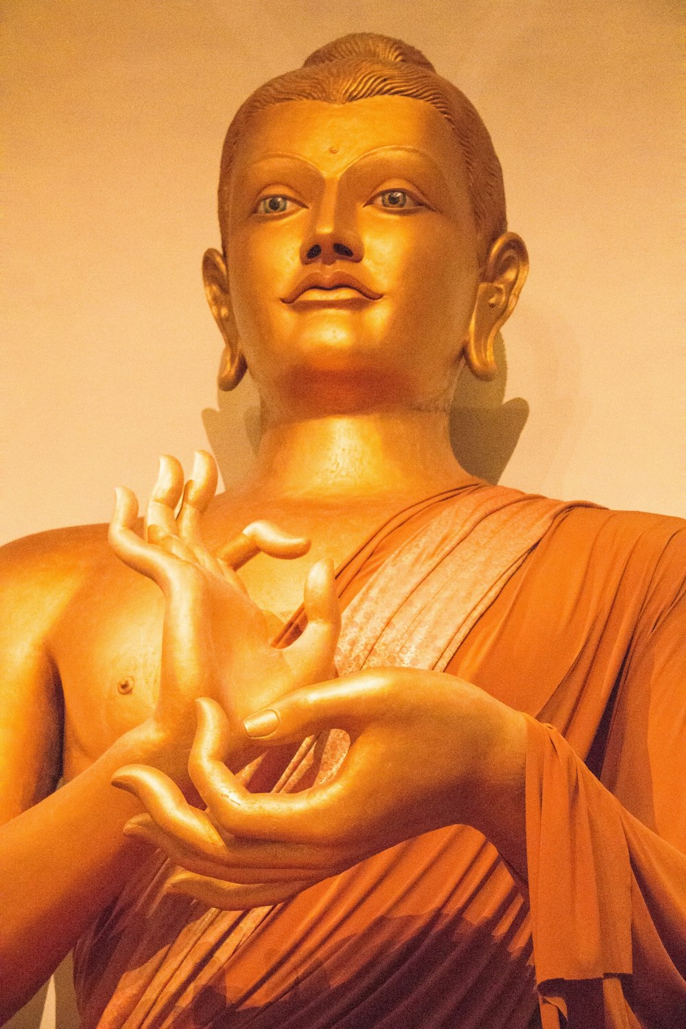 gold buddha statue in white room
