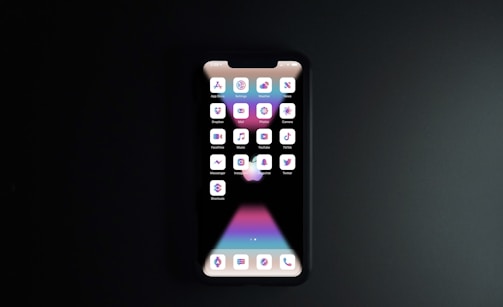 black iphone 4 turned on displaying icons