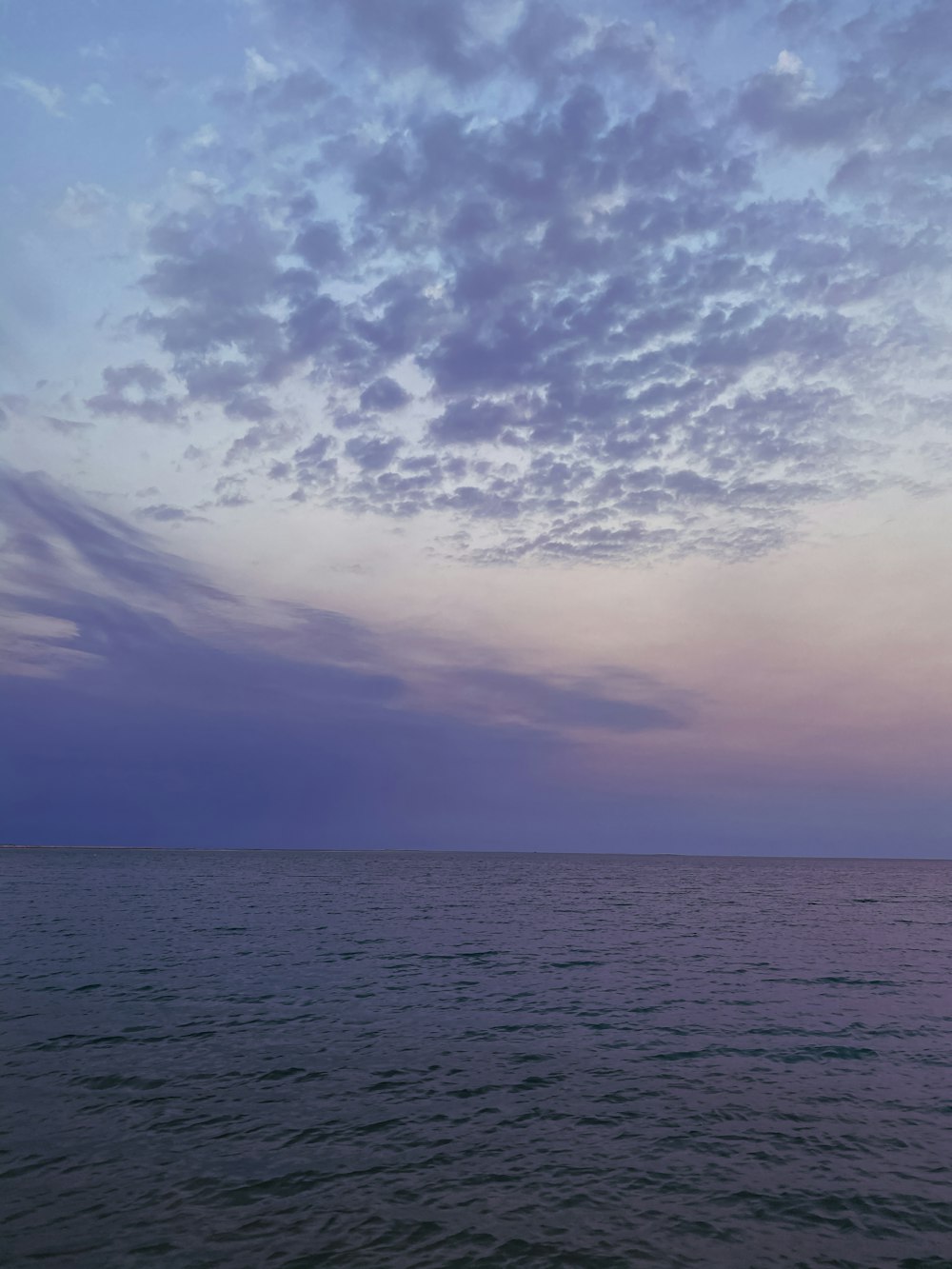 body of water under cloudy sky during daytime