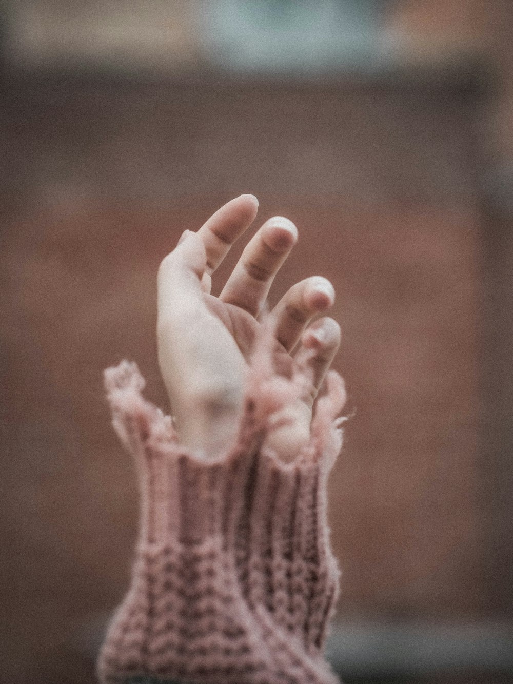 persons hand with pink manicure