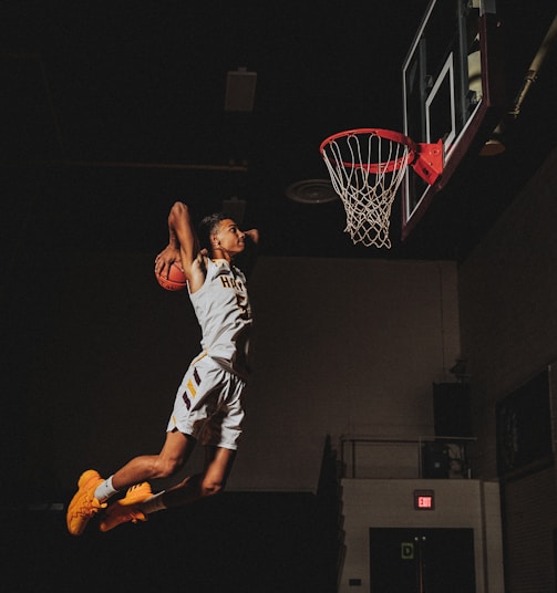 2 boys playing basketball on basketball court