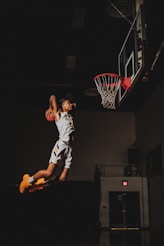 2 boys playing basketball on basketball court