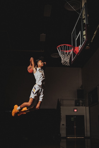 2 boys playing basketball on basketball court