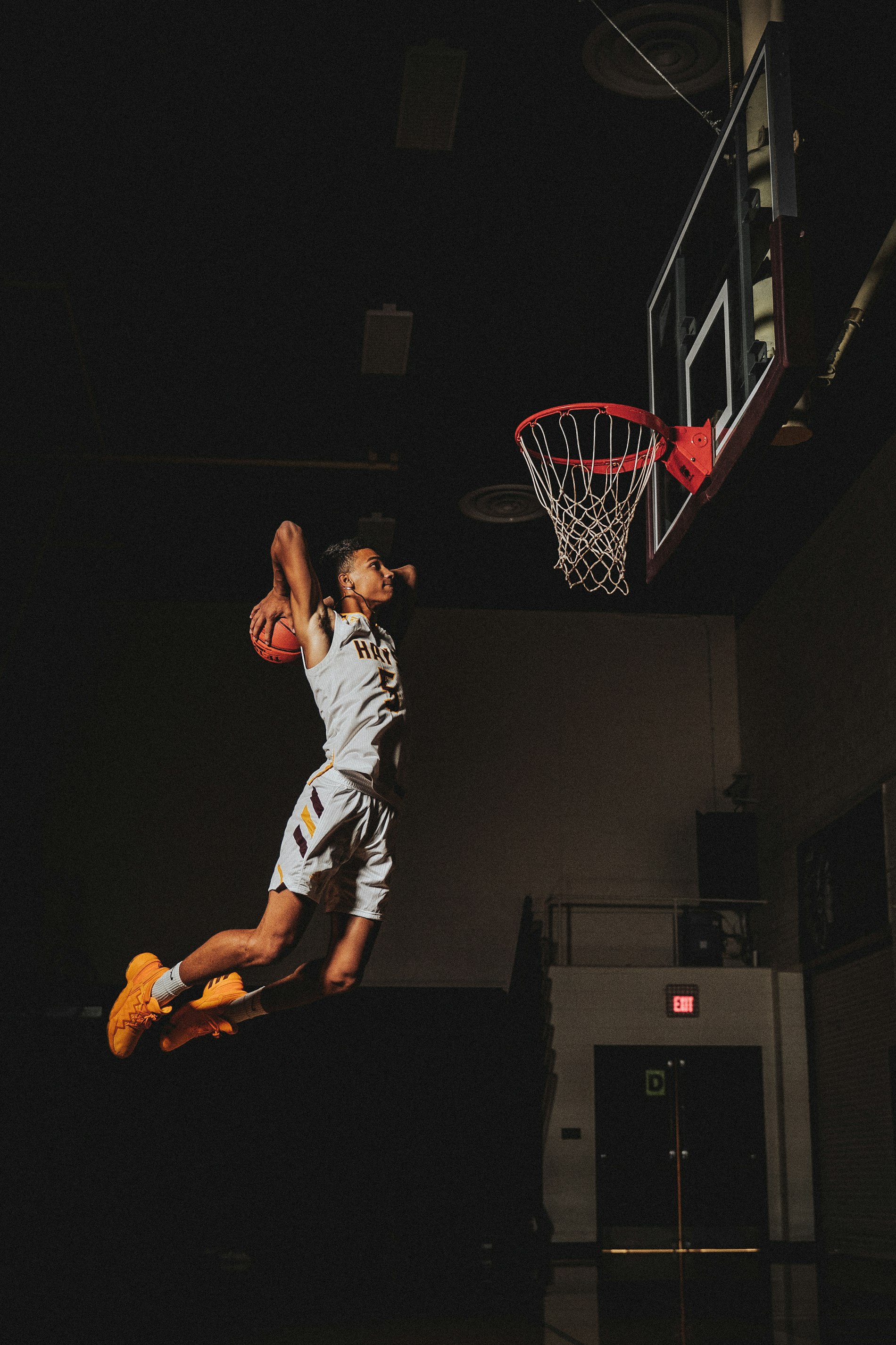 High school basketball player rising for a dunk