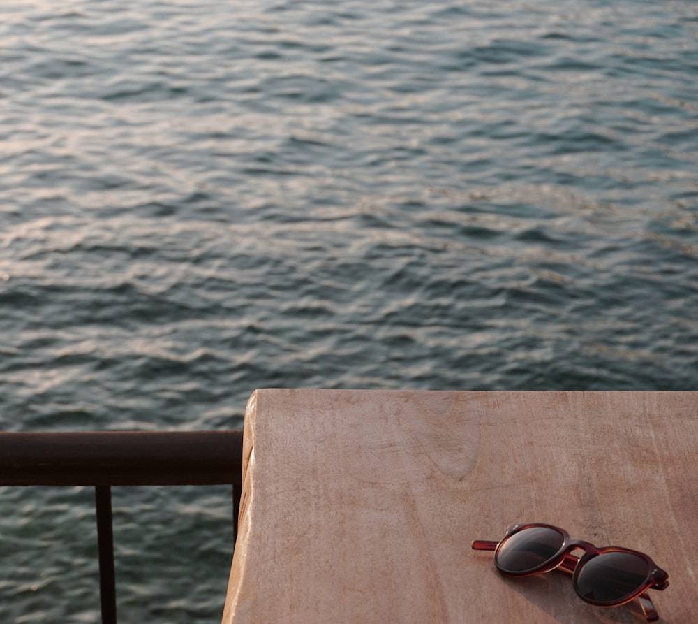 brown wooden bench near body of water during daytime