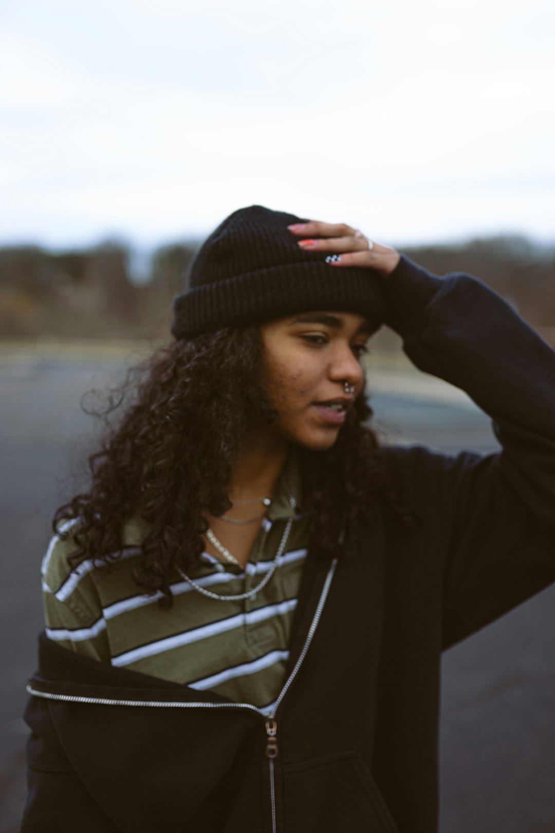 woman in black and white striped long sleeve shirt and black knit cap
