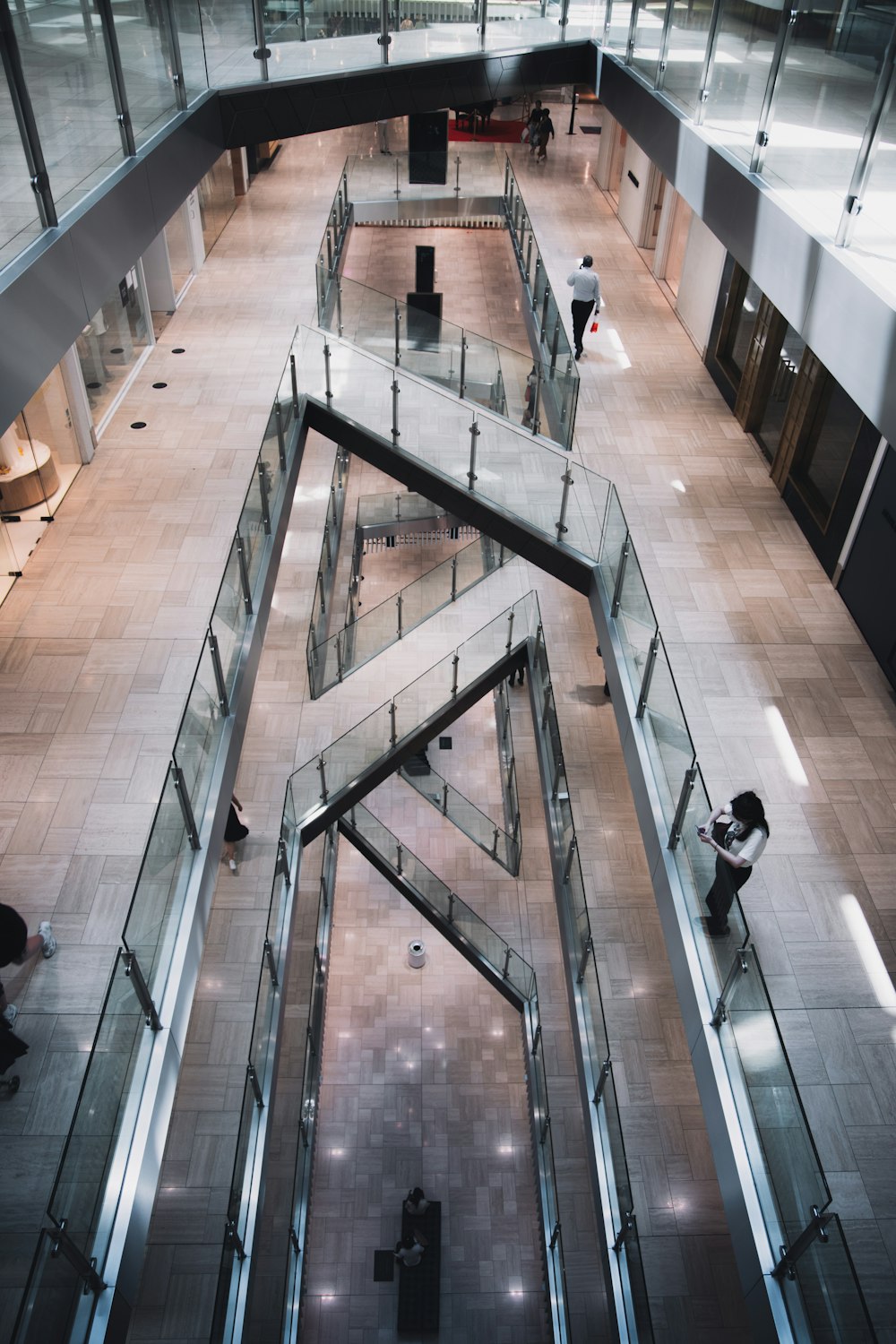 people walking on brown wooden floor