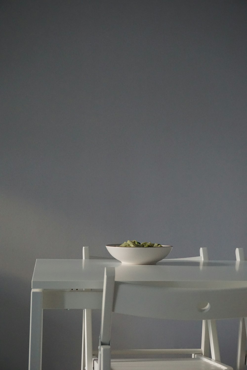 white ceramic bowl on white wooden table