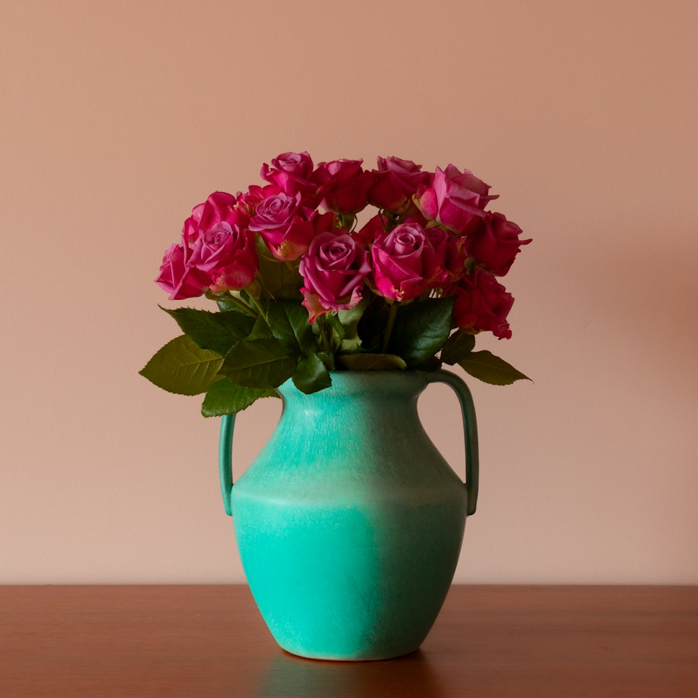 pink and purple flower in blue ceramic vase