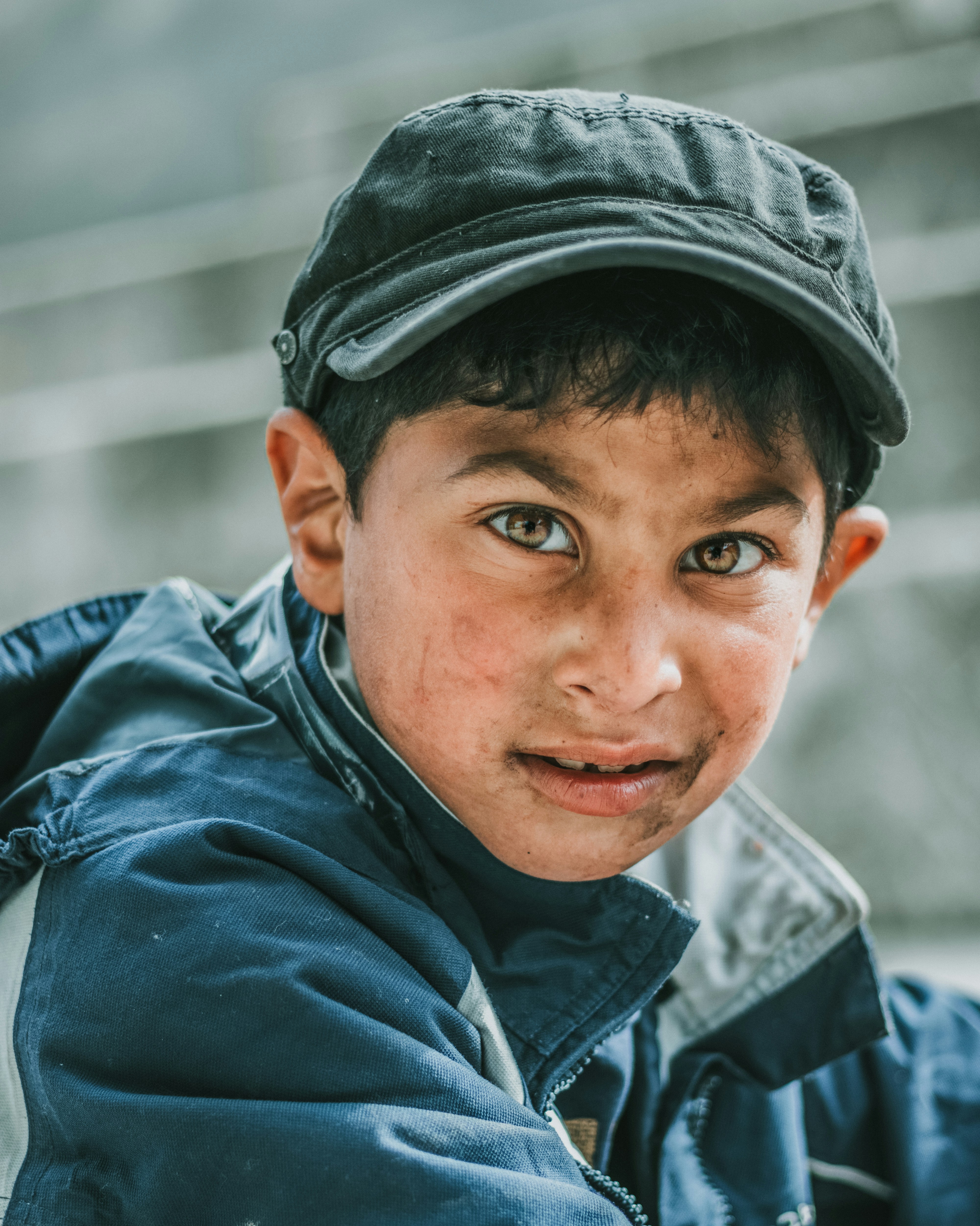 I was taking some pictures of one of my best friend when, all the sudden, this child pop out of nowhere on his little tricycle. He looked at me with interest while i was taking pictures so I decided to ask him : \