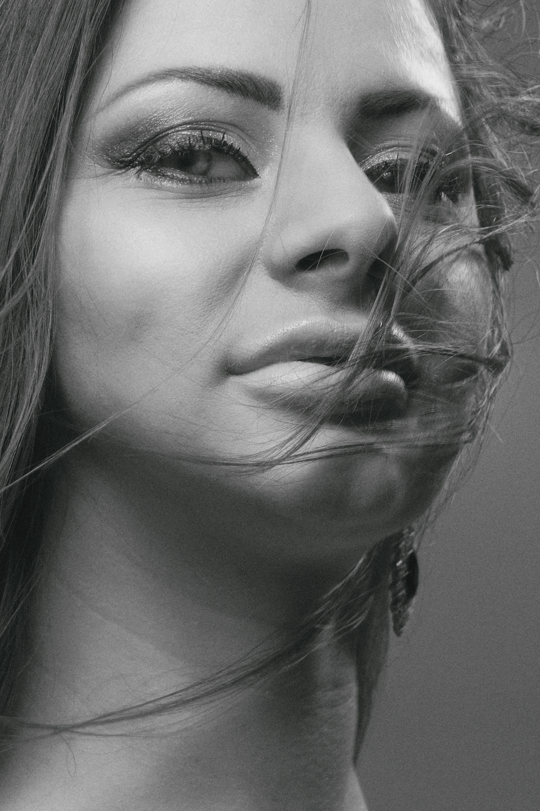 grayscale photo of woman with nose piercing