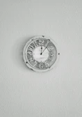 Custom resin clock with a smooth, glossy finish and gentle pastel hues hanging on a white wall.