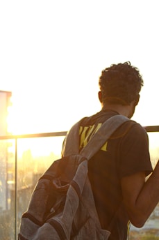 man in brown t-shirt with brown backpack