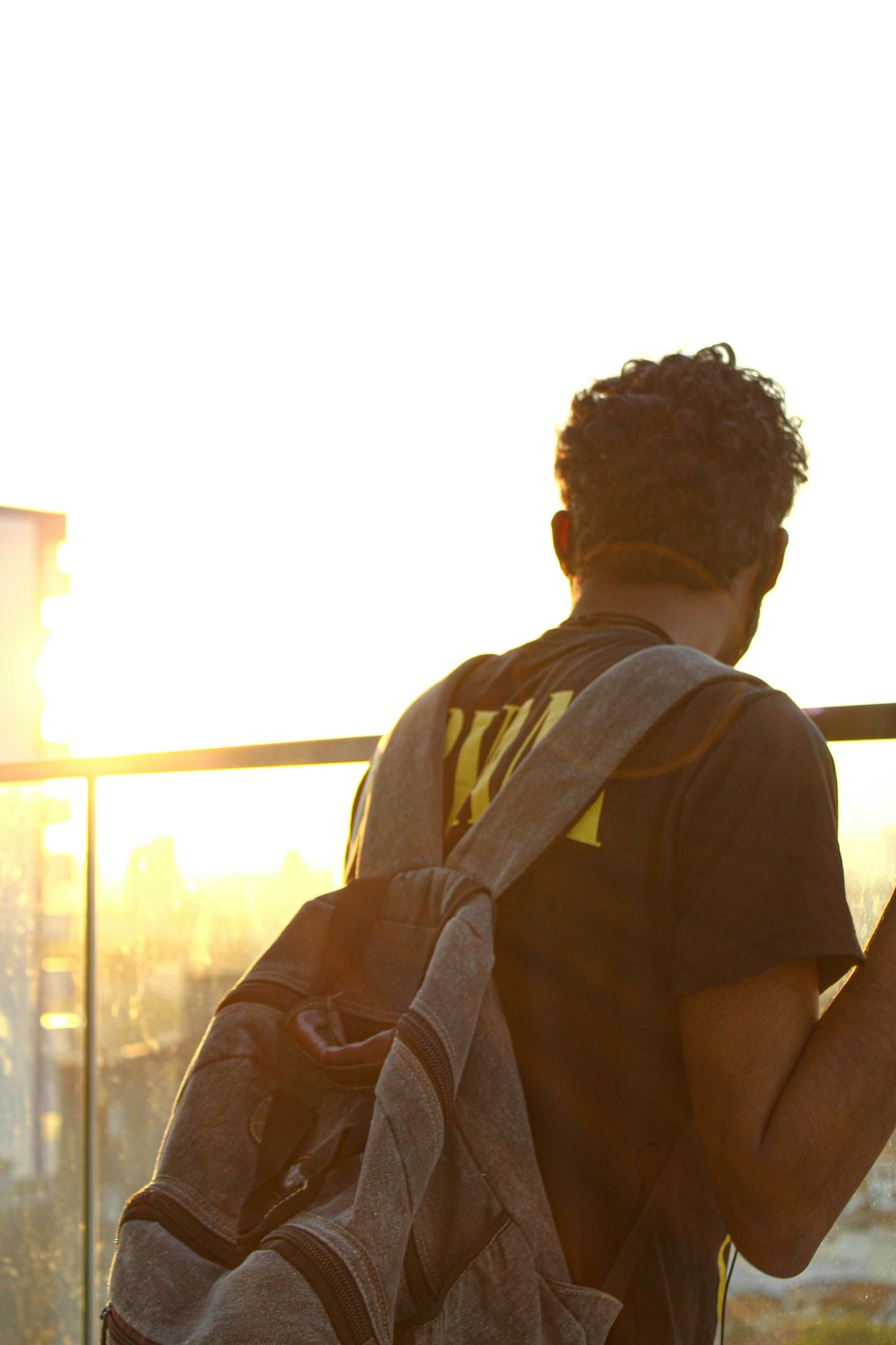 man in brown t-shirt with brown backpack