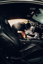 man in black t-shirt driving car