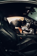 man in black t-shirt driving car