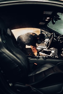 man in black t-shirt driving car