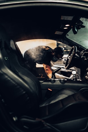 man in black t-shirt driving car