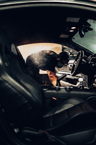 man in black t-shirt driving car