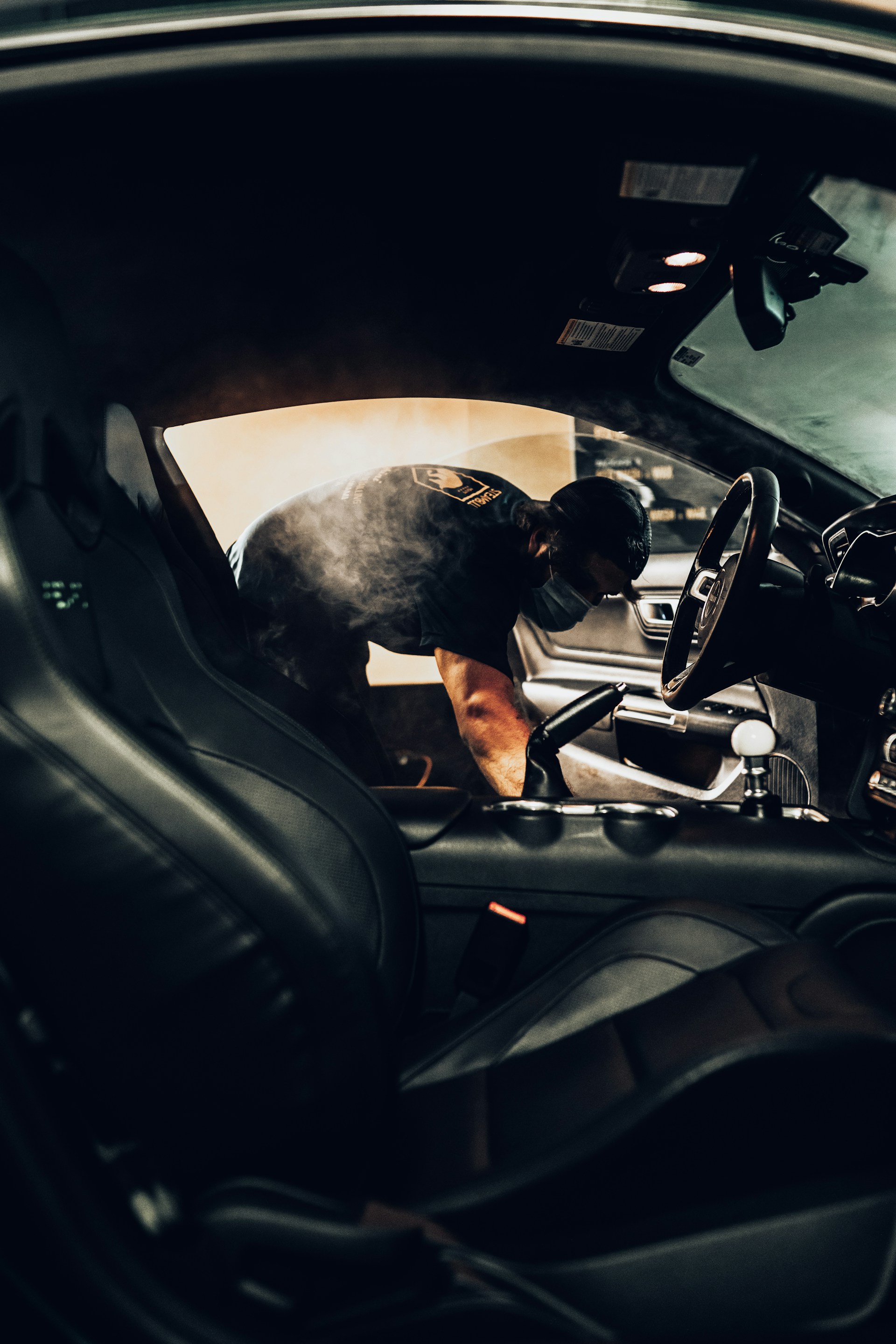 man in black t-shirt driving car