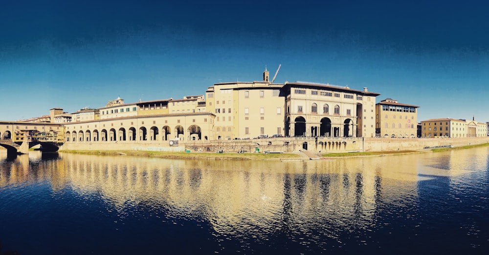 white concrete building beside body of water during daytime