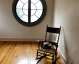 A warm, inviting corner featuring a handcrafted wooden rocking chair.